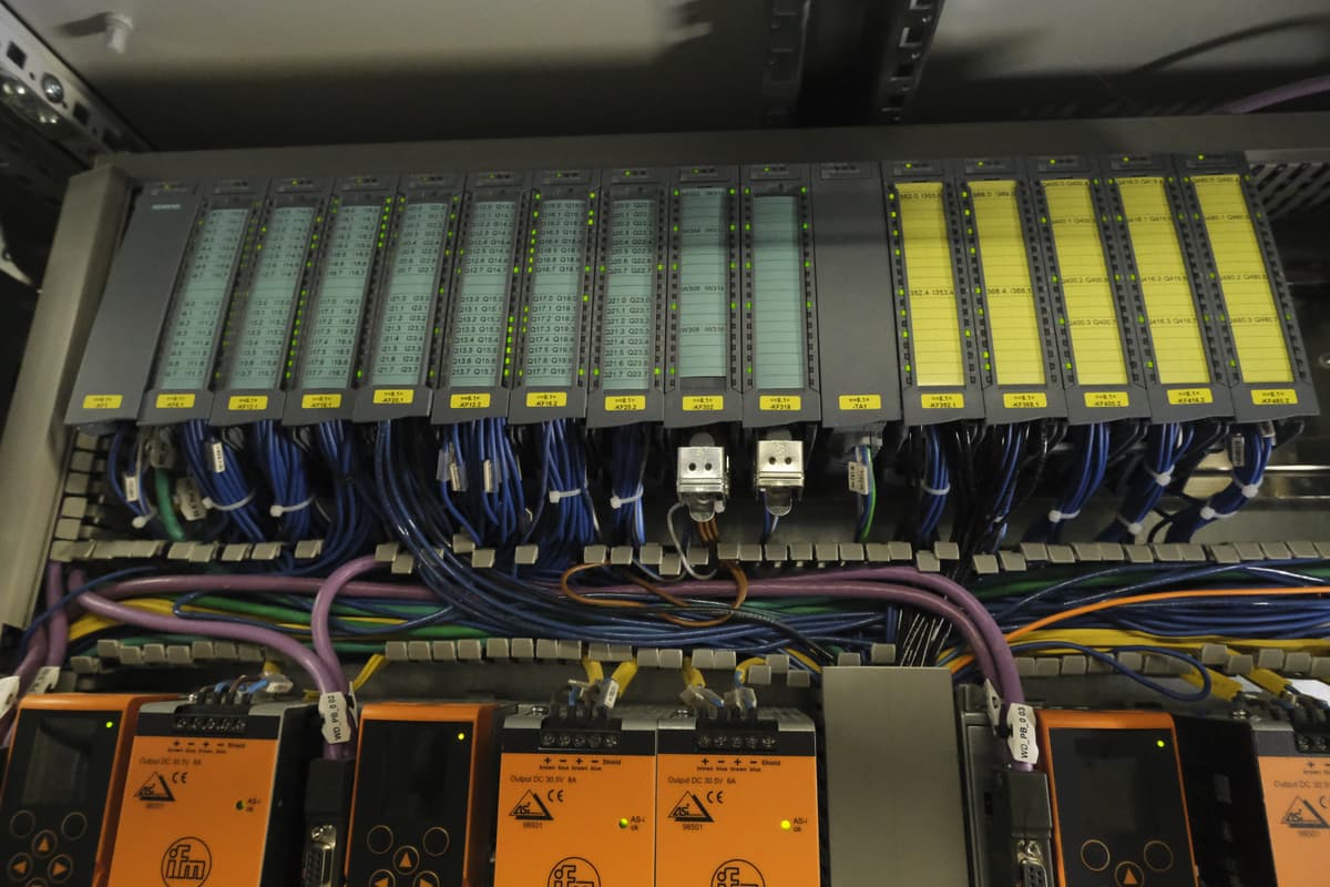 Industrial automation control cabinet with PLC and VFD integration